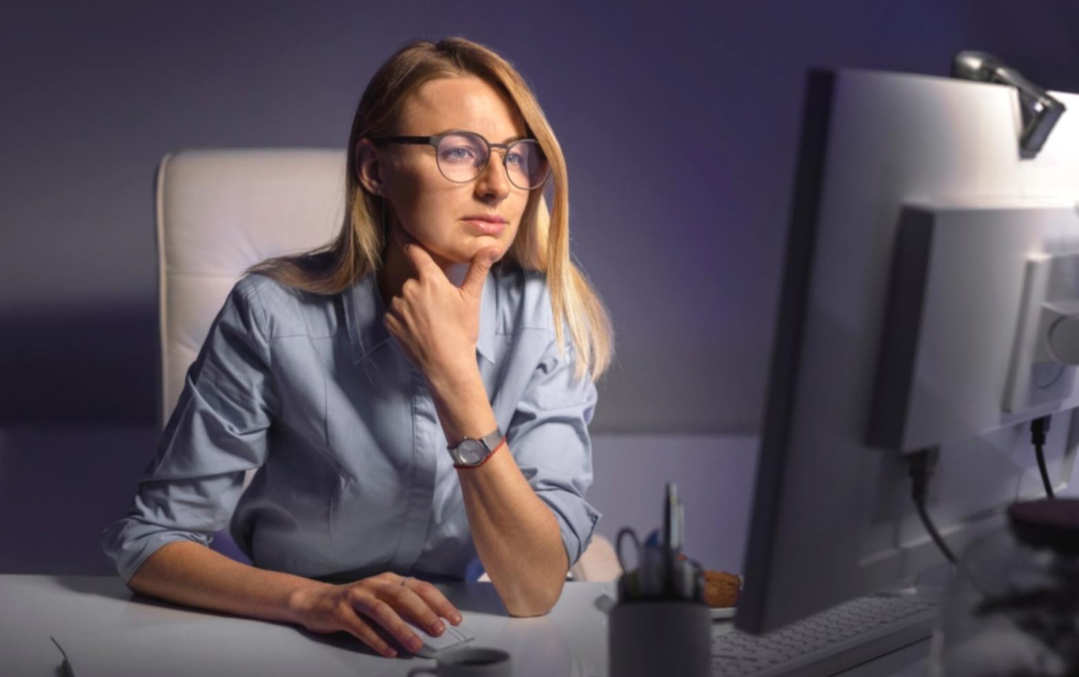 Developer working on low-level code with hardware components visible on desk